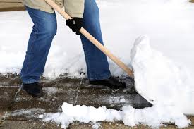 physiotherapy oakville how to shovel snow without pain, picture of a person shoveling heavey snow