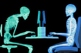 Oakville physiotherapy, 2 skeletons sitting at a computer desk, one with good posture, the other slouching over thei keyboard